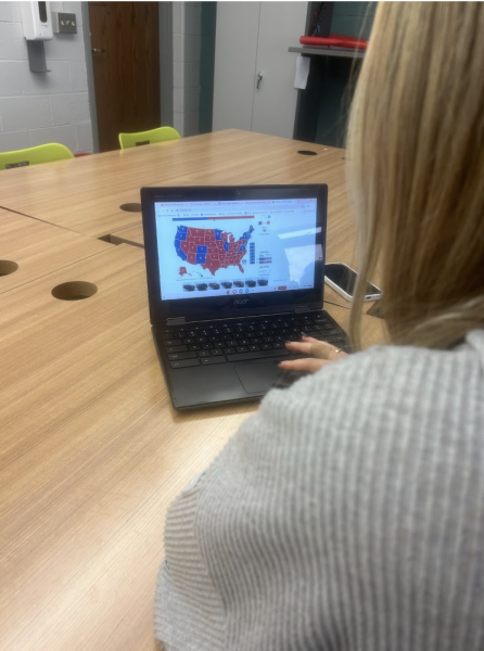 Vanessa Jovanovic, senior, looks at an interactive map of the electoral college for the 2024 election.
